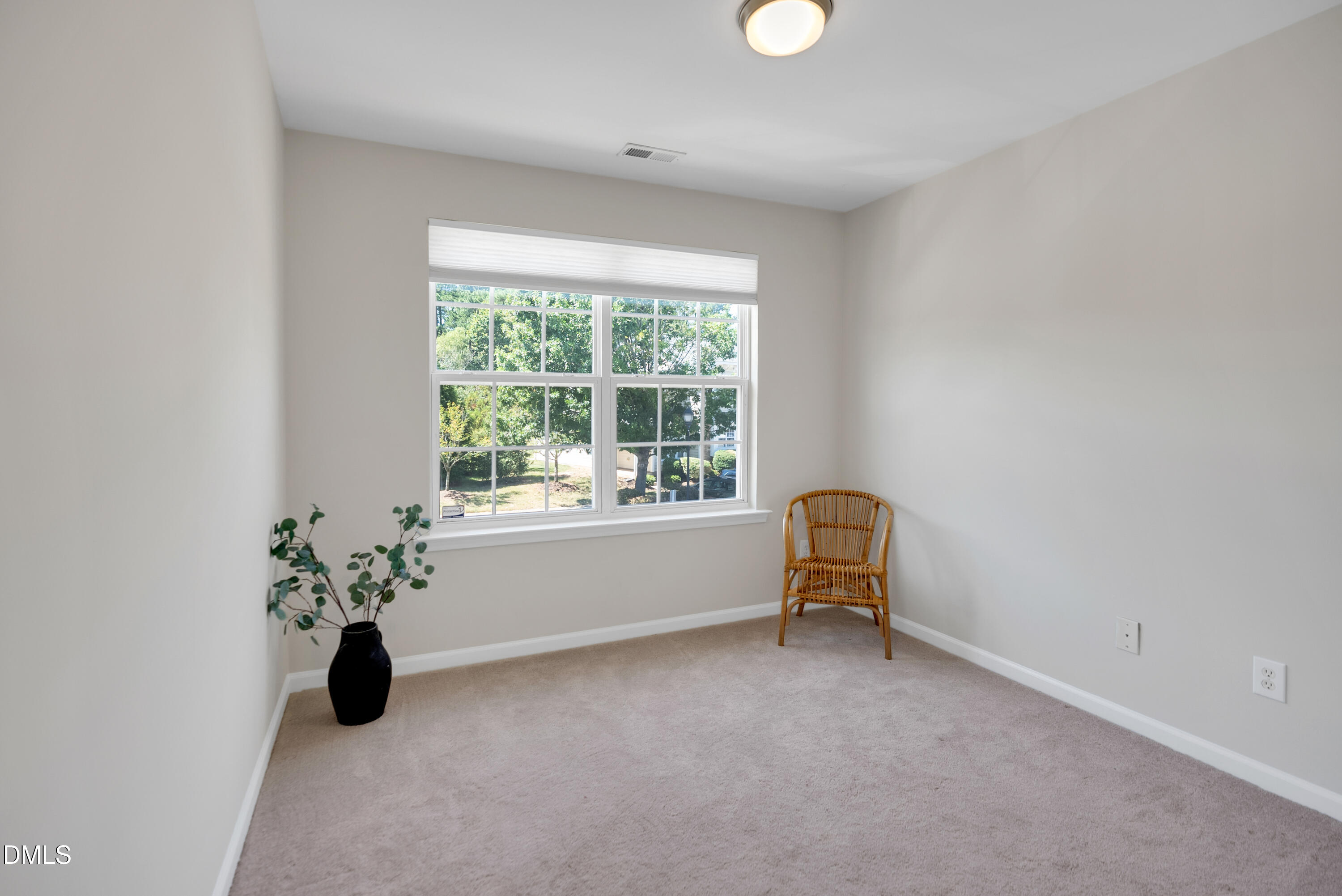 3617 Sugar Tree Place Durham, NC 27713 - Photo 33 of 38 an empty room with windows and chair