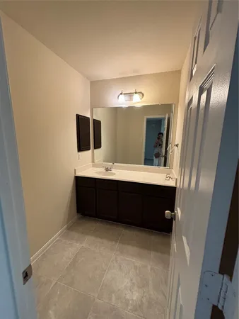 a bathroom with a double vanity sink and mirror