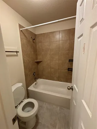 a bathroom with a sink a toilet and a shower