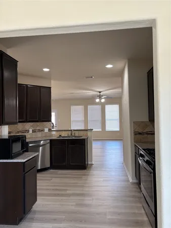 a large kitchen with stainless steel appliances