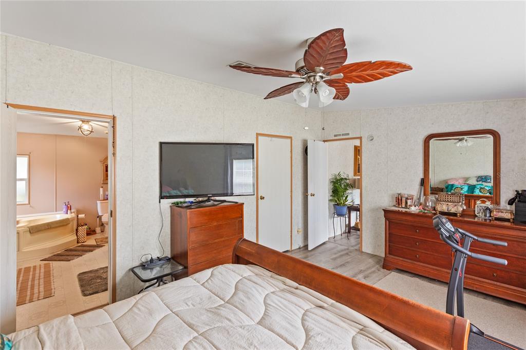 5670 Acadia Street Keystone Heights, FL 32656 - Photo 44 of 65 a bedroom with furniture and a flat screen tv