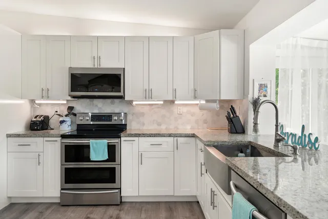 a kitchen with a refrigerator stove and microwave