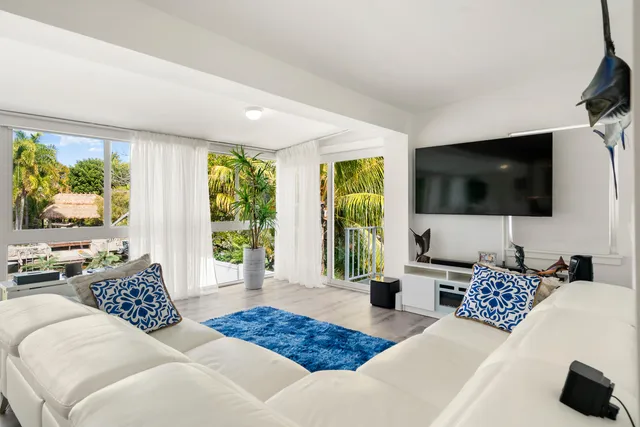a living room with a large window and a table