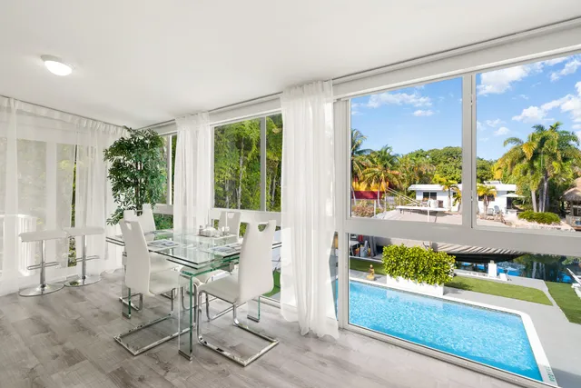 a view of a living room with furniture and a large window