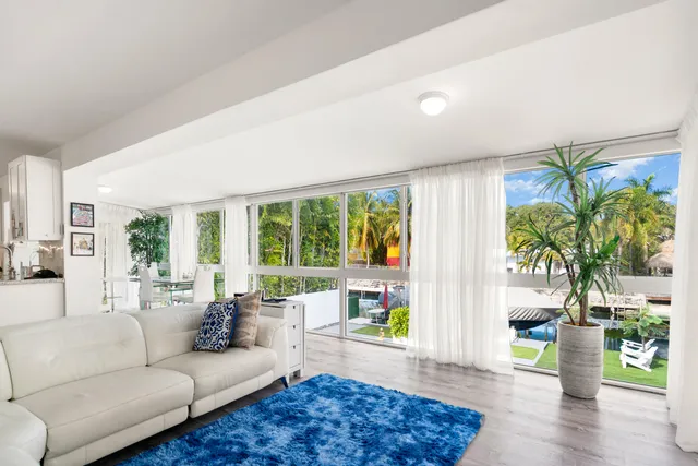 a living room with furniture and a potted plant