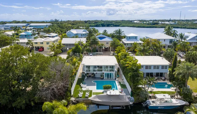 a view of a lake with a table and chairs under an umbrella