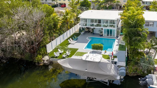 swimming pool view with a seating space and a garden