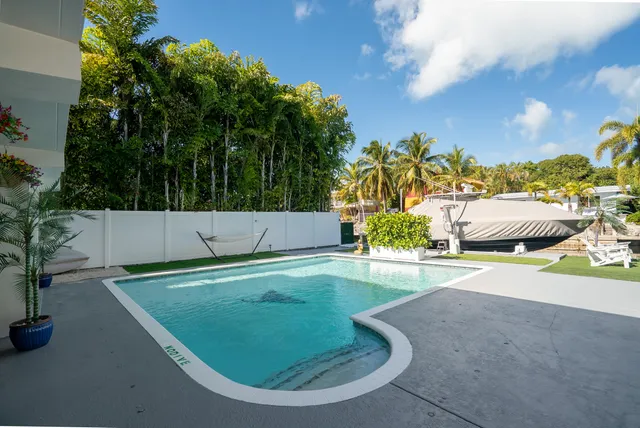 a view of a chair and table in backyard of the house
