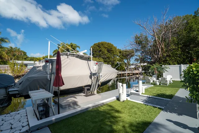 a view of swimming pool with outdoor seating and plants