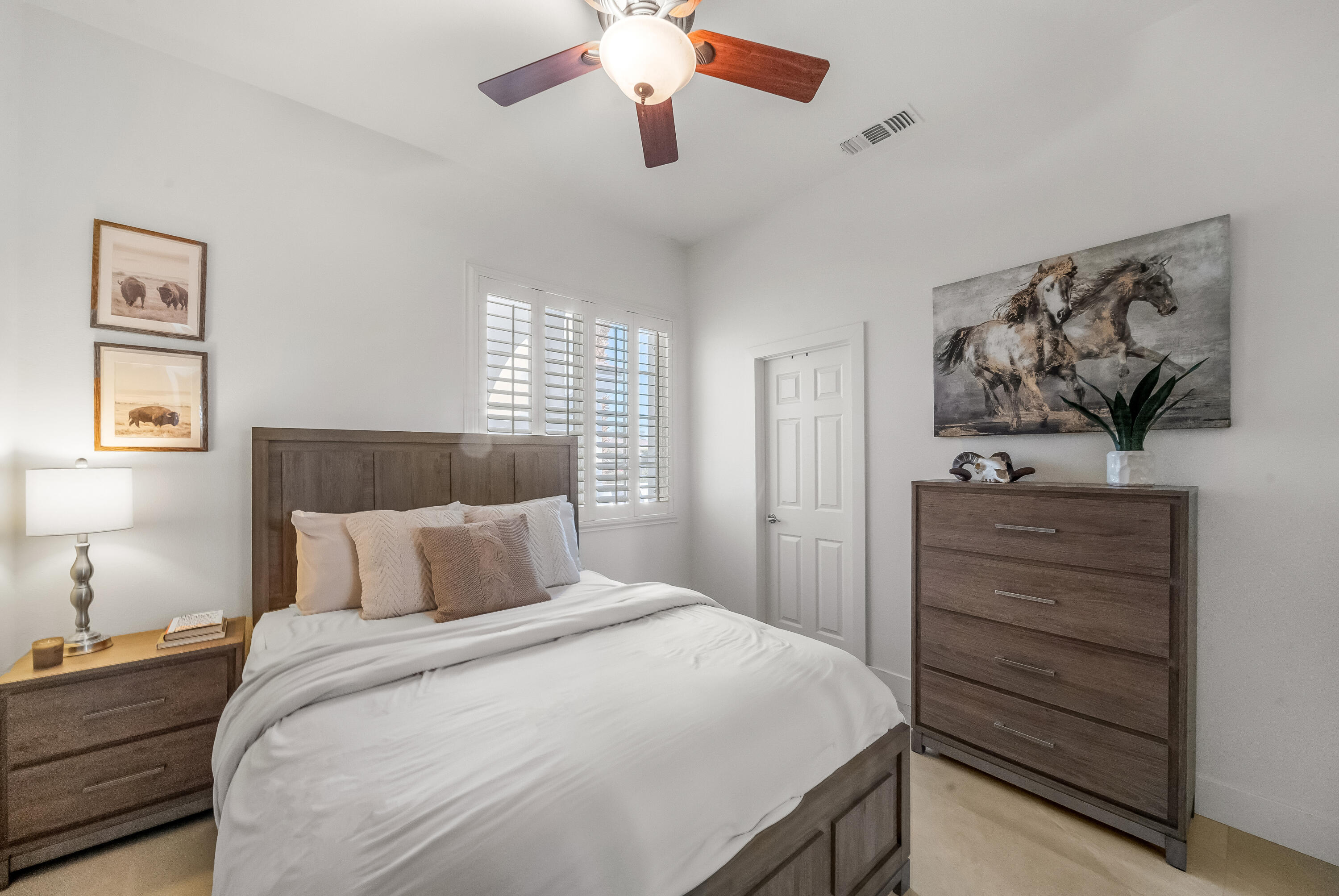 80262 Amazon Avenue Indio, CA 92201 - Photo 39 of 69 a bedroom with a bed and a chandelier