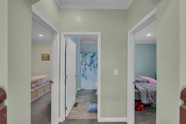 a view of hallway with walk in closet and bathroom