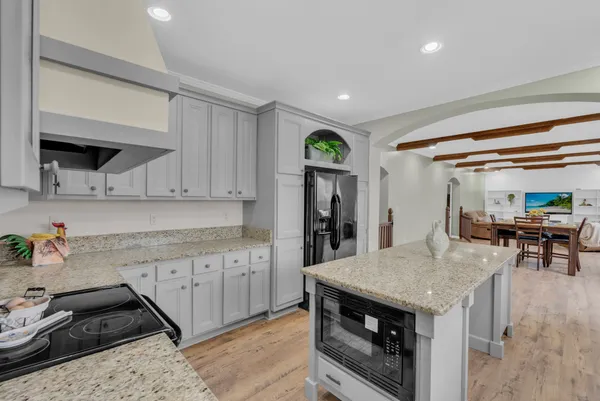 a kitchen with a stove and a refrigerator