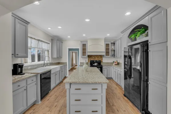 a kitchen with a sink stove and refrigerator