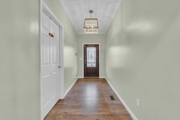 a view of a hallway with wooden floor