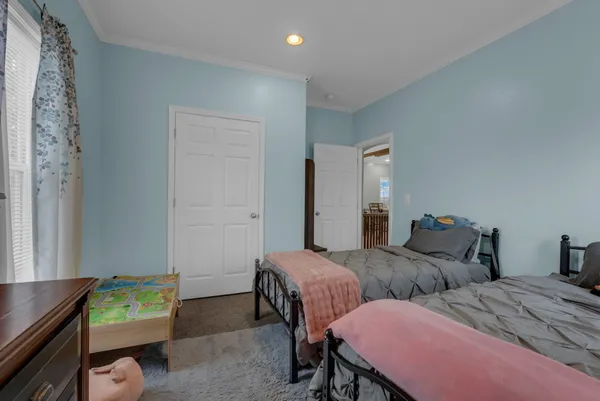 a bedroom with two beds and a desk