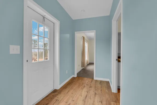 a view of hallway with wooden floor