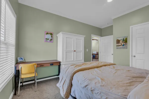 a bedroom with a bed and a chair