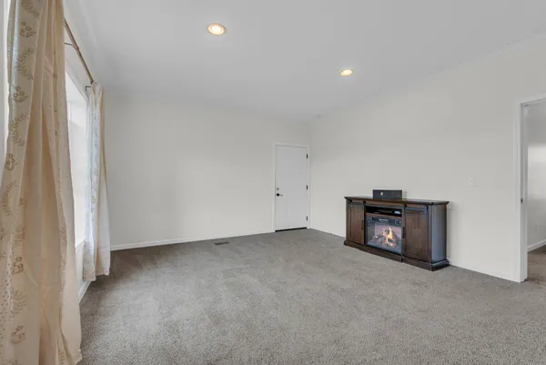 a view of a room with a fireplace and a window