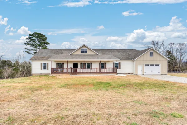 a view of a house with a yard and swimming pool