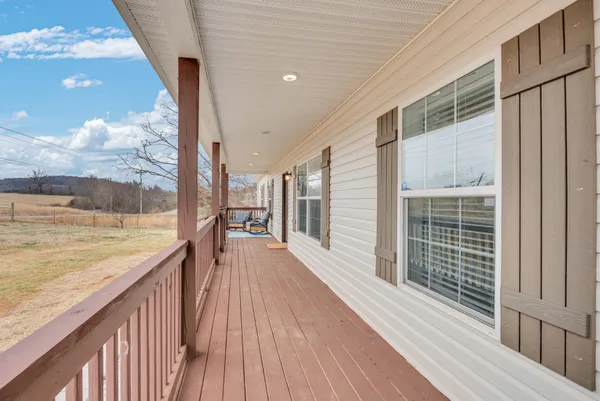 a view of a balcony with wooden floor