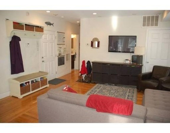 14 Homer Street, Unit 3 Brookline, MA 02445 - Photo 2 of 10 a living room with furniture and a flat screen tv
