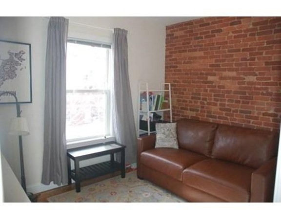 14 Homer Street, Unit 3 Brookline, MA 02445 - Photo 4 of 10 a living room with furniture and a window