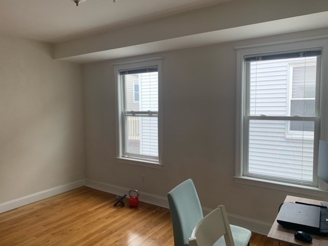 14 Homer Street, Unit 3 Brookline, MA 02445 - Photo 6 of 10 a room with a window and wooden floor