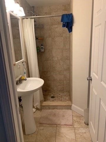14 Homer Street, Unit 3 Brookline, MA 02445 - Photo 7 of 10 a bathroom with a sink a toilet and shower