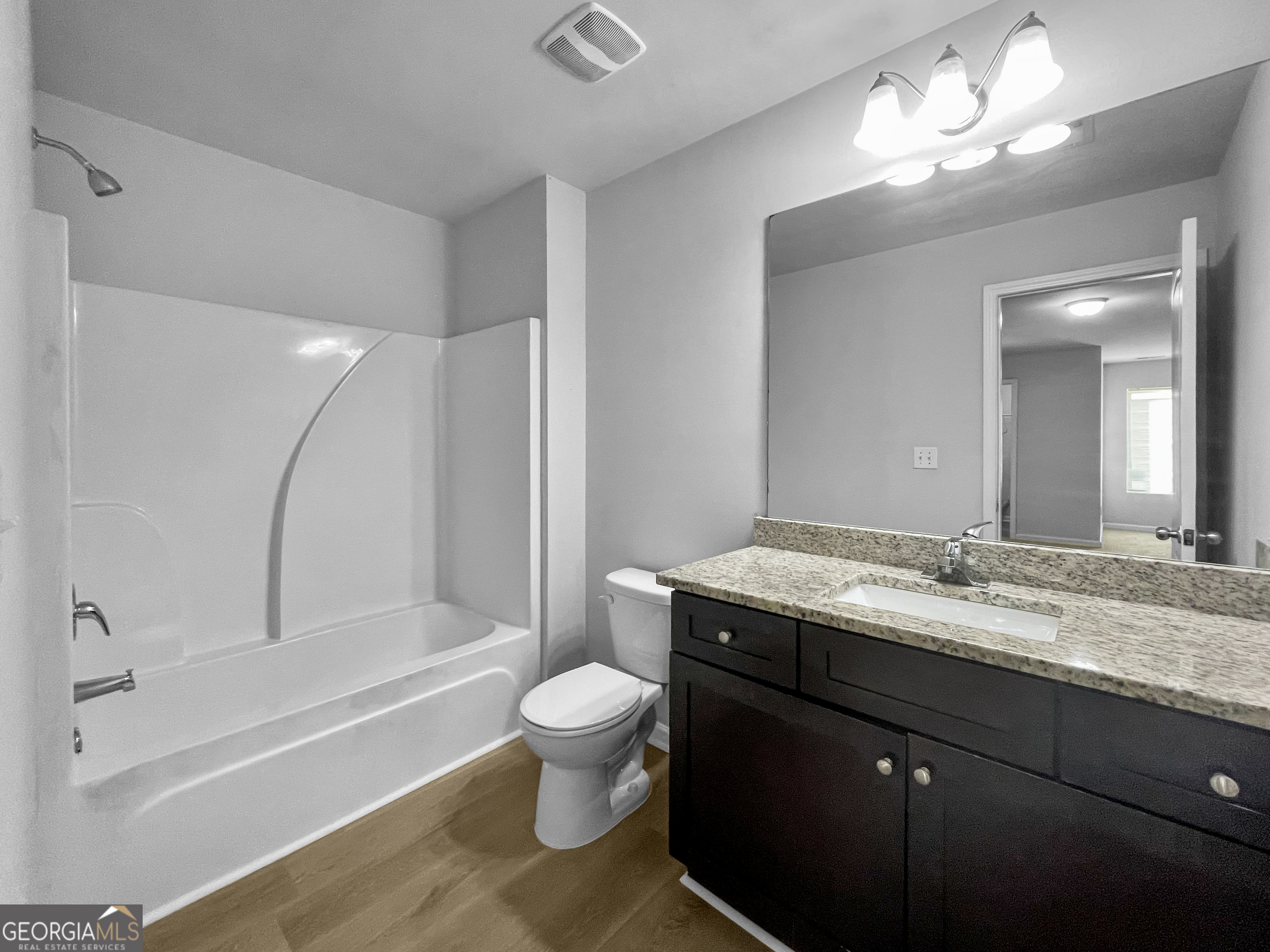 116 Daisy Circle McDonough, GA 30252 - Photo 15 of 18 a bathroom with a granite countertop sink a toilet and bathtub