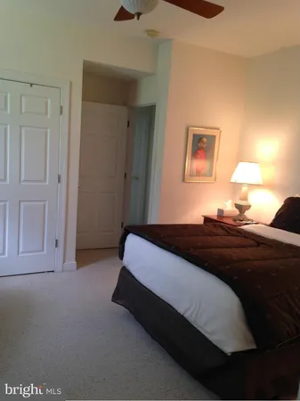 a bedroom with a bed and lamps