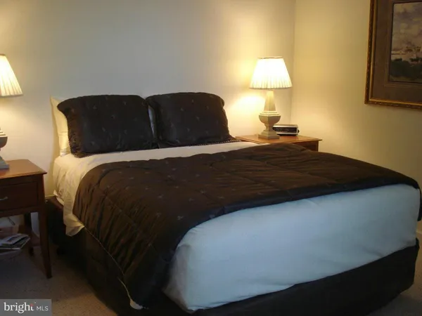 a bedroom with a bed and a lamp