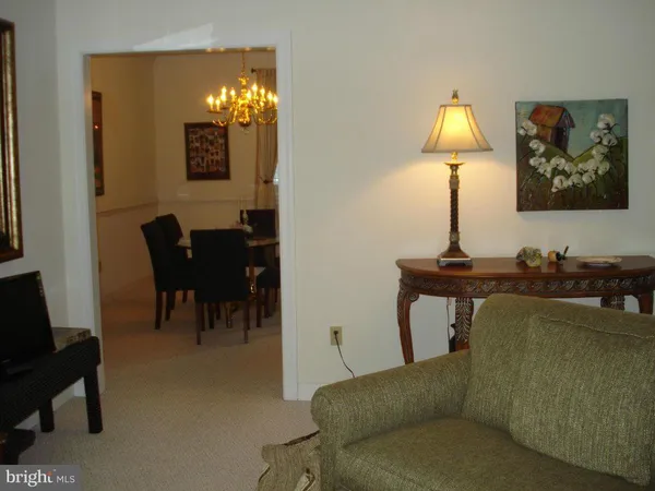 a living room with furniture and a lamp