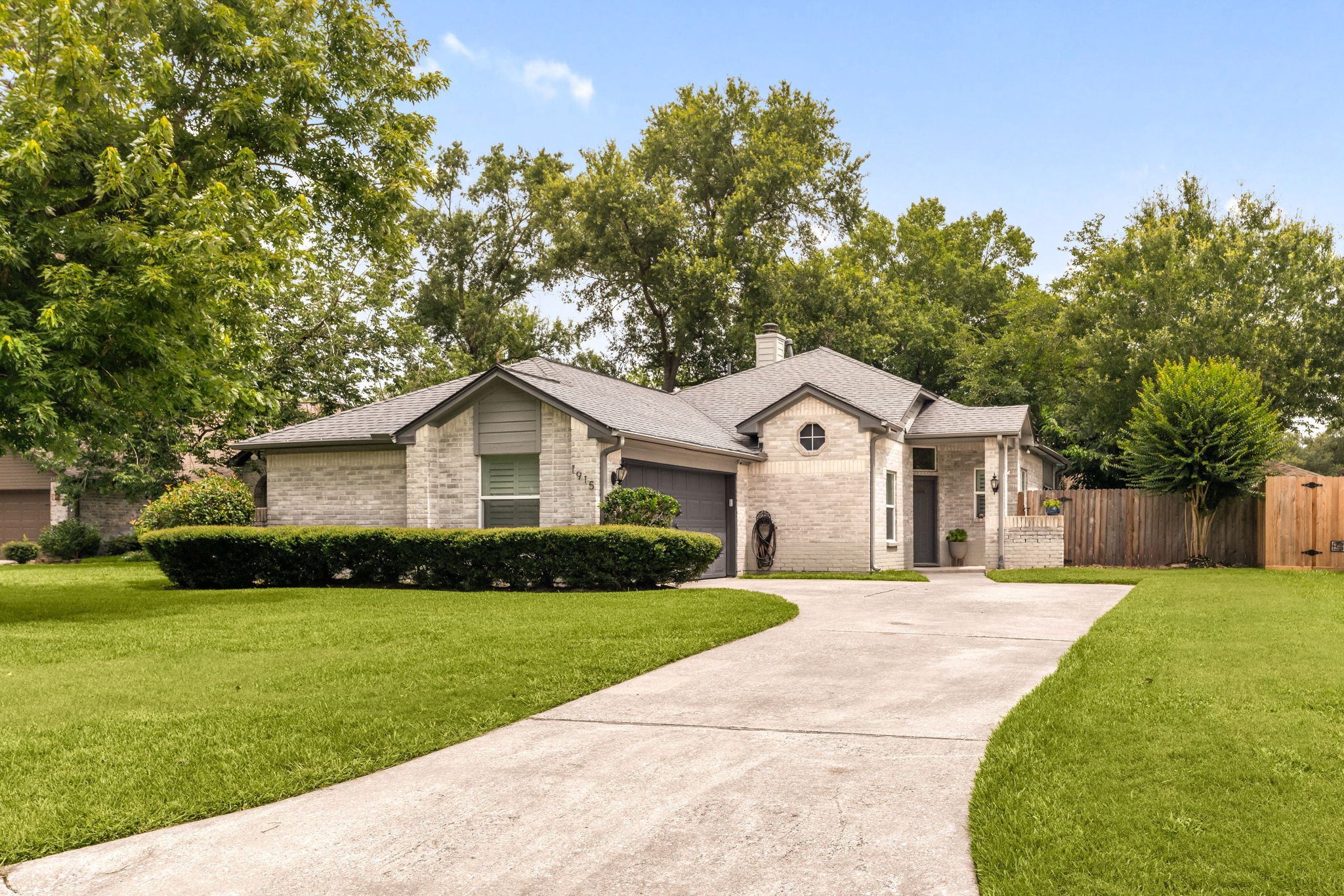 1915 Mercoal Drive Spring, TX 77386 - Photo 4 of 50 Beautiful front façade showcasing lush landscaping and a generous front lawn.