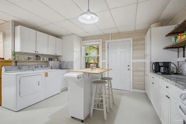 a kitchen with cabinets appliances and a window
