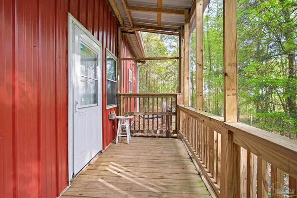 a view of a porch with wooden floor and stairs