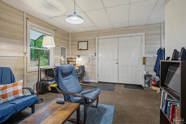 a view of a livingroom with furniture hardwood floor and a window
