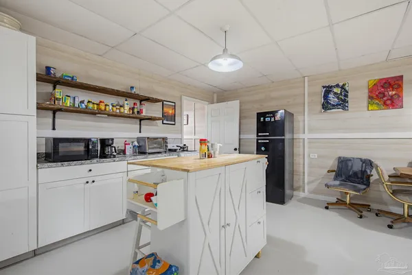 a kitchen with refrigerator and cabinets