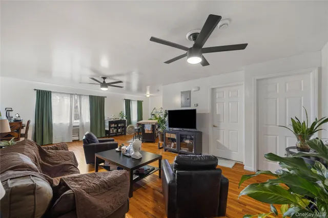a living room with furniture a dining table and a fireplace