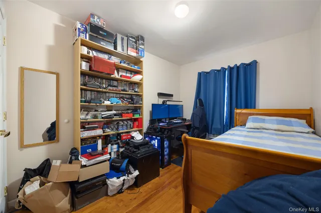 a bedroom with a bed and a book shelf