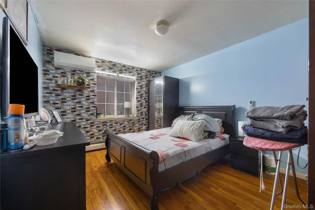 a room with furniture a flat screen tv and a refrigerator