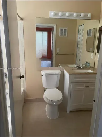 a bathroom with a sink toilet and mirror