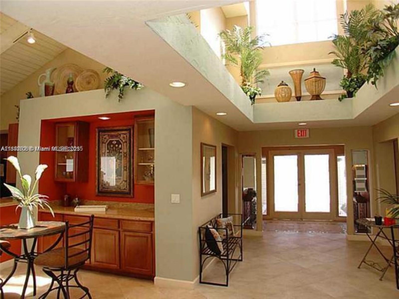 651 Lyons Road, Unit 10201 Coconut Creek, FL 33063 - Photo 4 of 16 a living room with furniture
