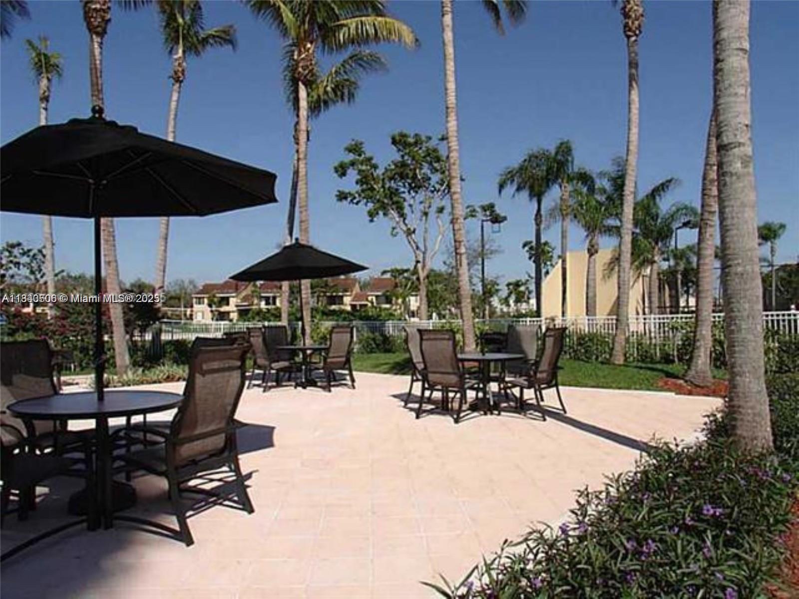 651 Lyons Road, Unit 10201 Coconut Creek, FL 33063 - Photo 6 of 16 a view of swimming pool with outdoor seating