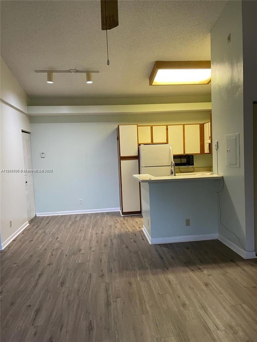 651 Lyons Road, Unit 10201 Coconut Creek, FL 33063 - Photo 10 of 16 a view of a kitchen with a sink and a window