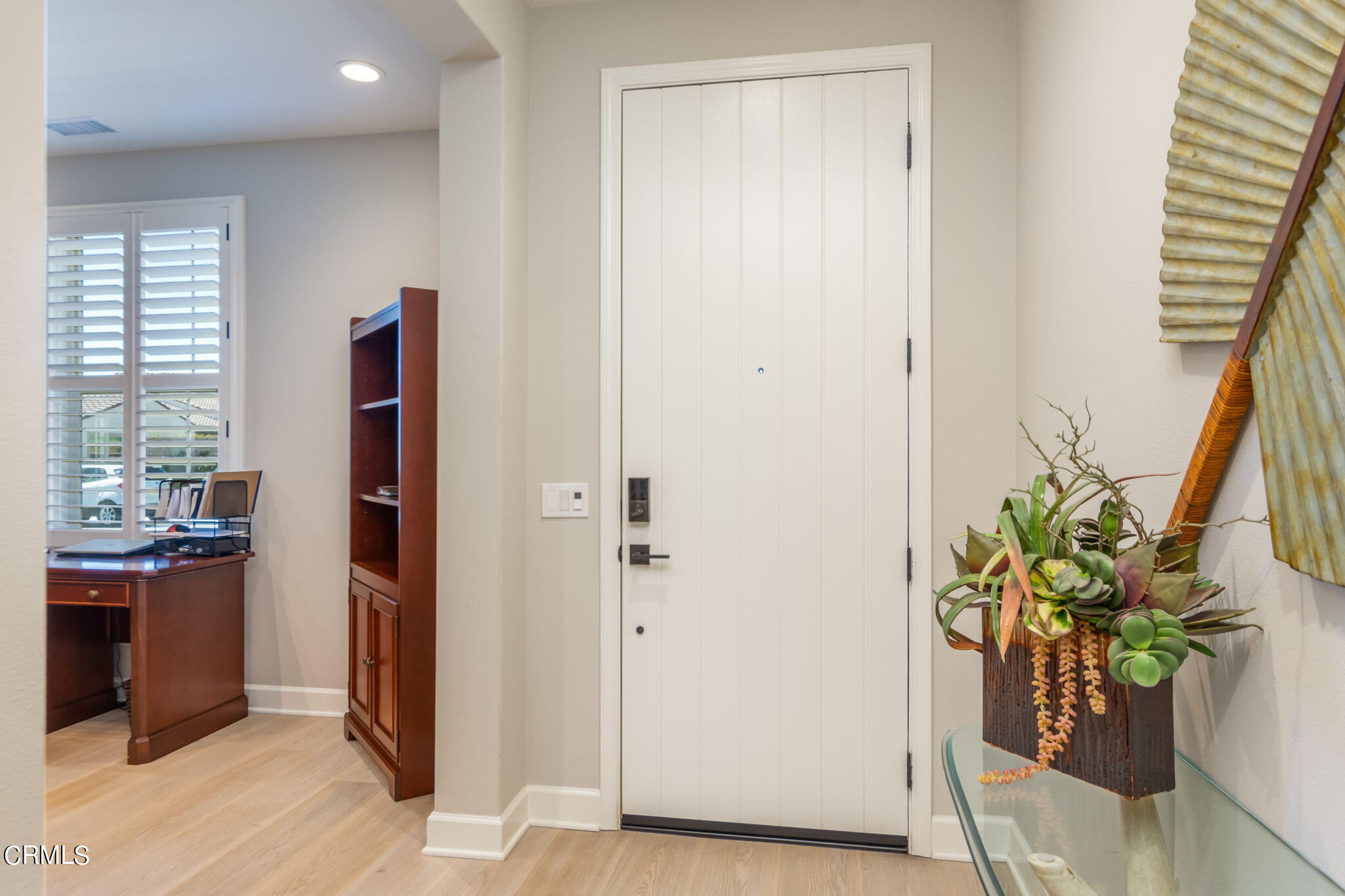 2474 Rondell Road Camarillo, CA 93012 - Photo 3 of 37 a view of a hallway with wooden floor and a potted plant