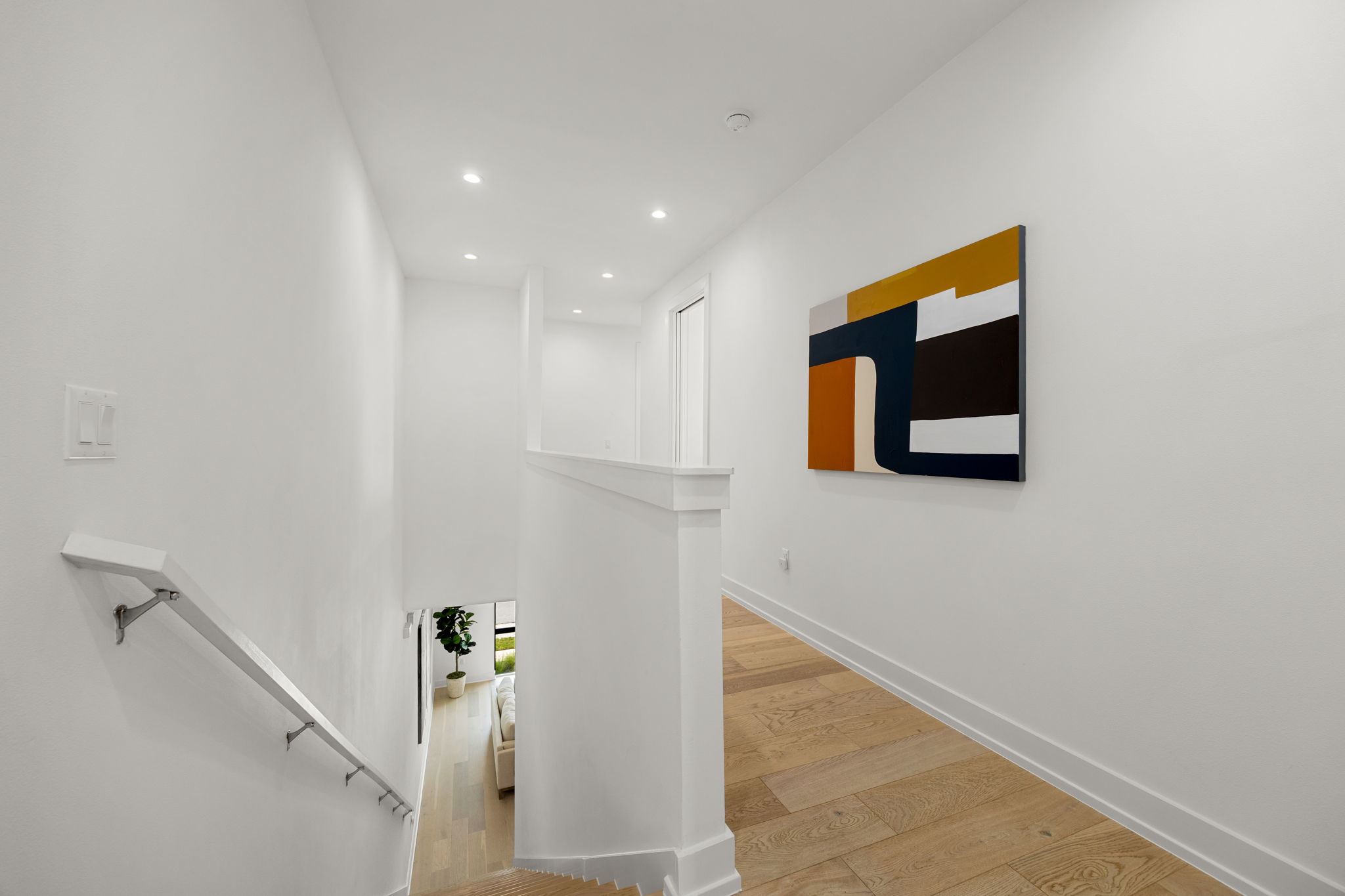 2524 Doc Reeves Street Austin, TX 78723 - Photo 20 of 36 Recessed lighting illuminates the clean lines of this upper-level hallway with rich hardwood flooring.