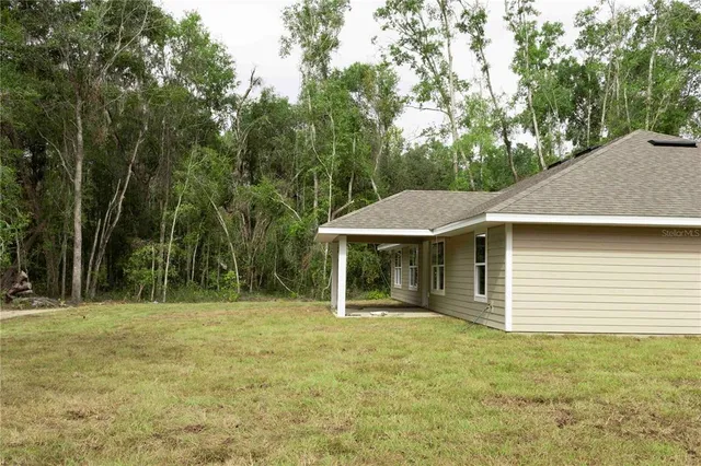 a view of a house with a backyard