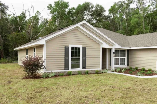 a view of a house with a yard and plants
