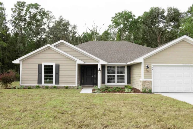 a view of front of house with garage and trees