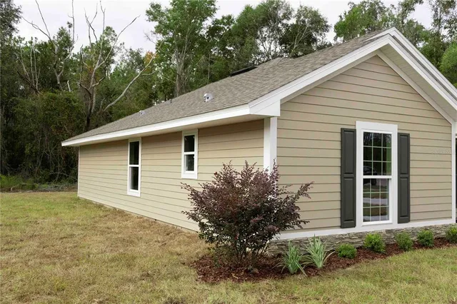 a view of a house with a yard and plants